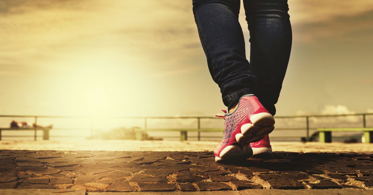 Blog background depicting woman walking with title "How Exercise Can Help With Burnout"