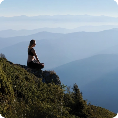 Woman sitting on a mountain