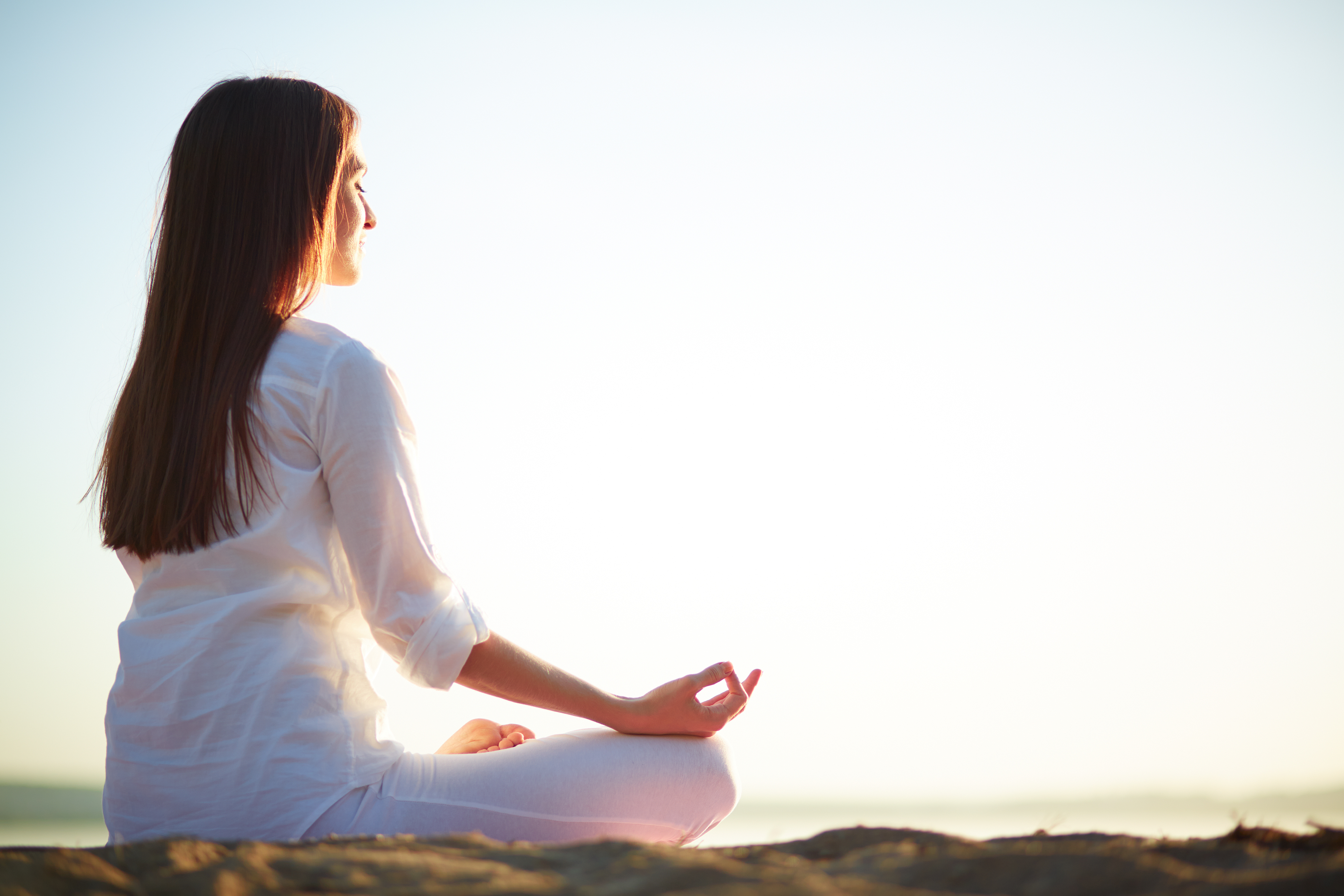 woman-sitting-yoga-pose-beach